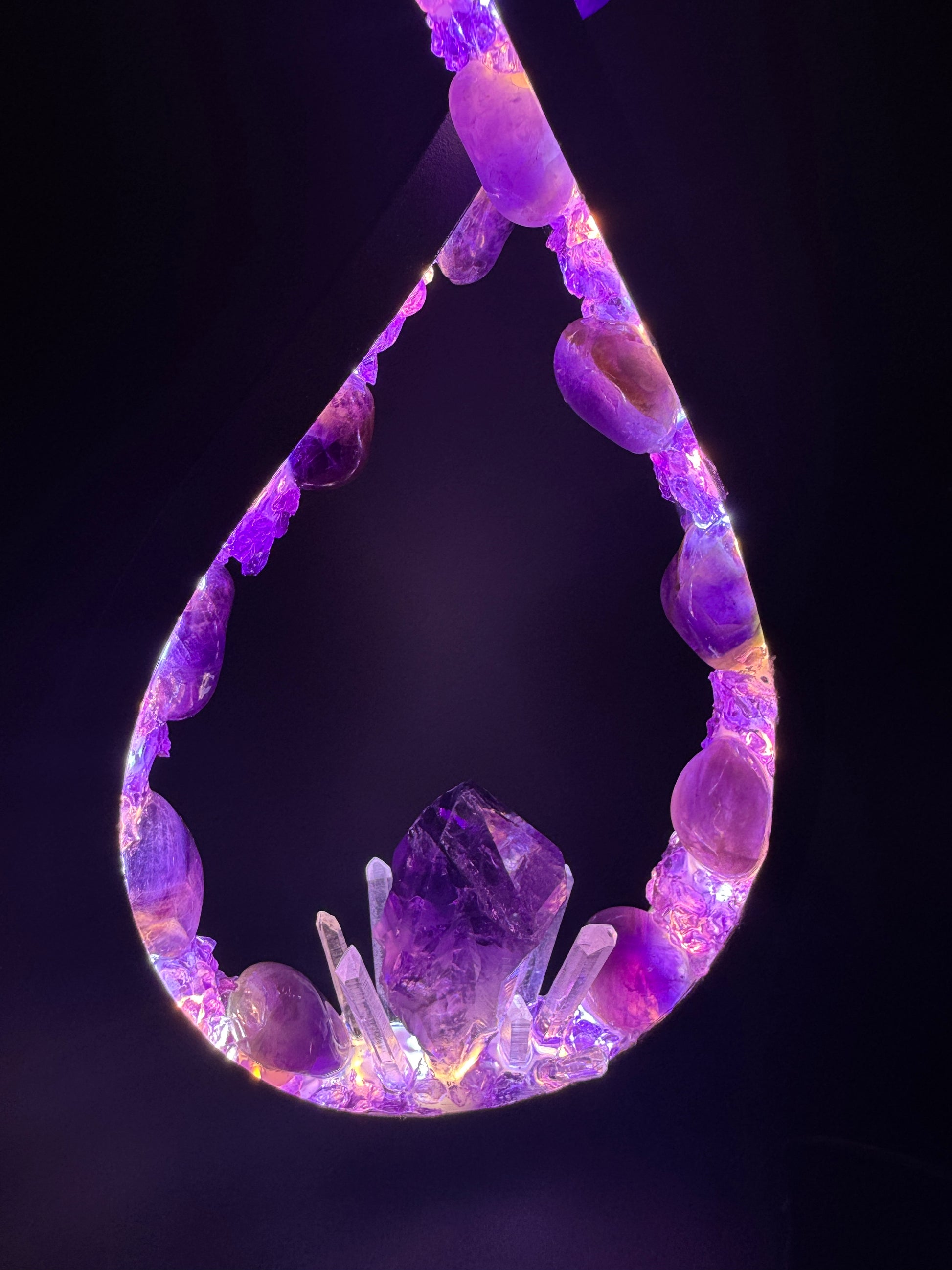 Crystal lamp featuring polished amethyst stones and a central amethyst point for a soothing violet glow.