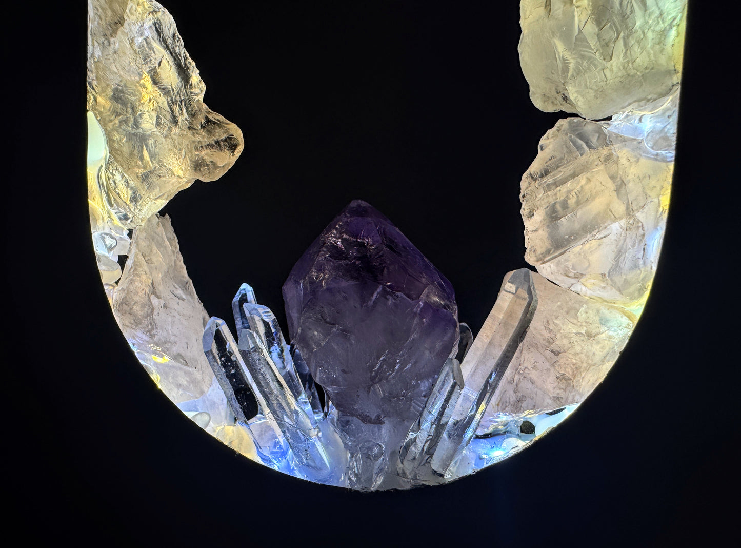 Close-up of the Opal Heart Crystal Portal Lamp featuring amethyst and clear quartz crystals illuminated from within.