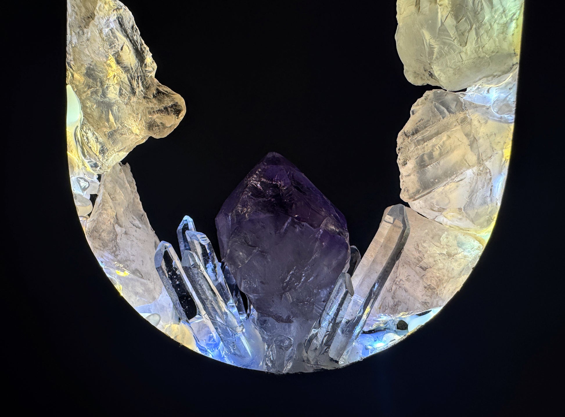 Close-up of the Opal Heart Crystal Portal Lamp featuring amethyst and clear quartz crystals illuminated from within.
