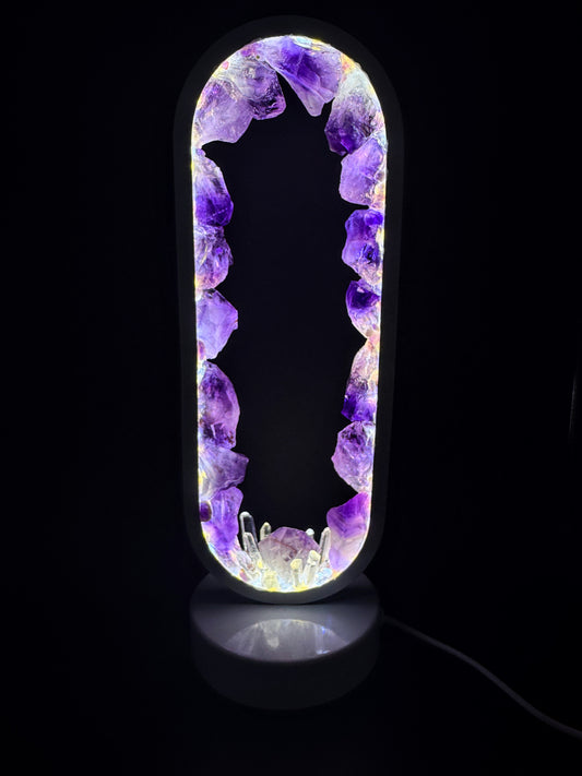 Crystal lamp featuring amethyst and clear quartz points, with a glowing purple light creating a serene ambiance.