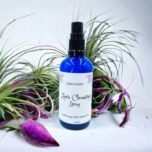 100ml bottle of aura cleansing spray in a blue glass bottle with bair plants in background
