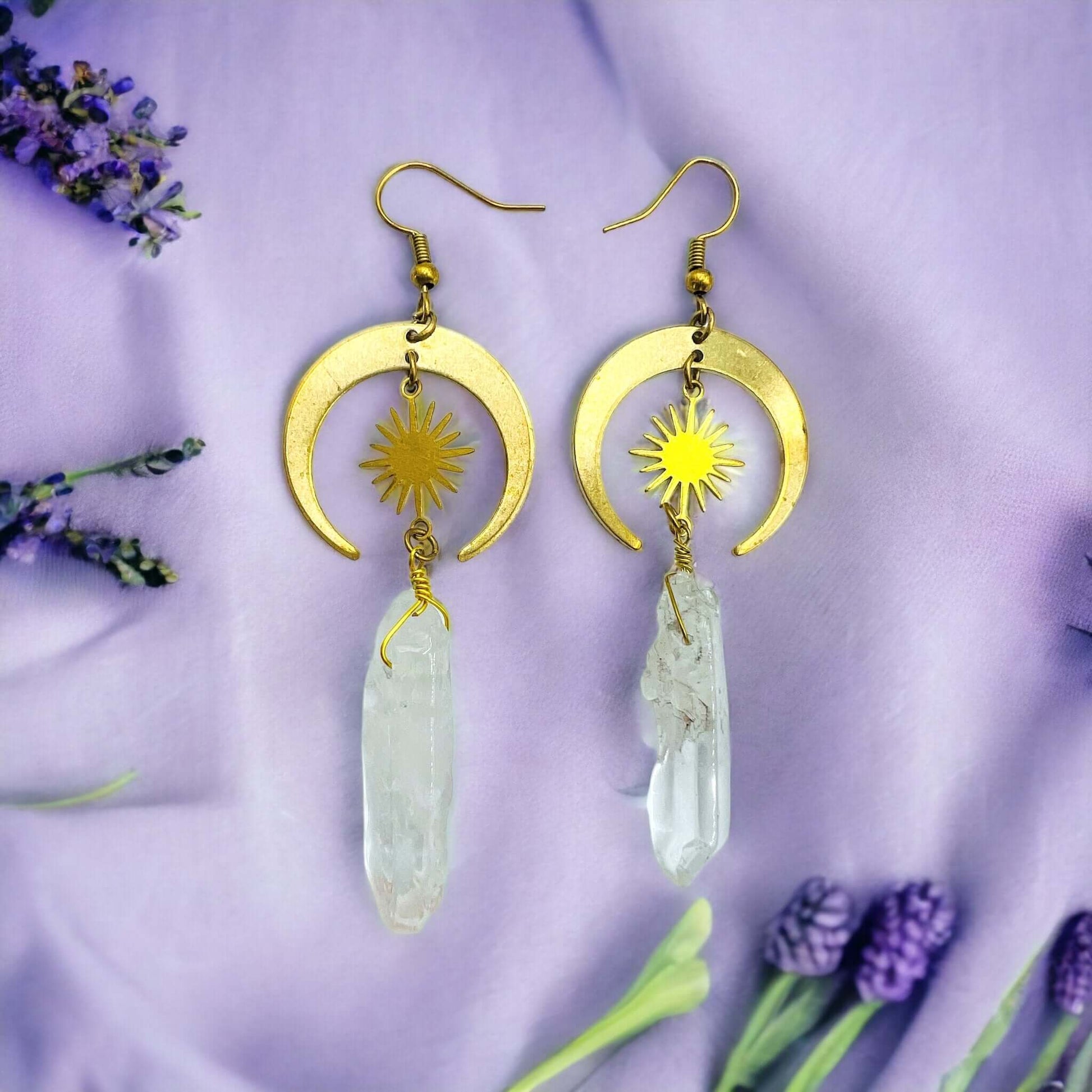 Gold Half Moon Earrings With Clear Quartz on purple fabric