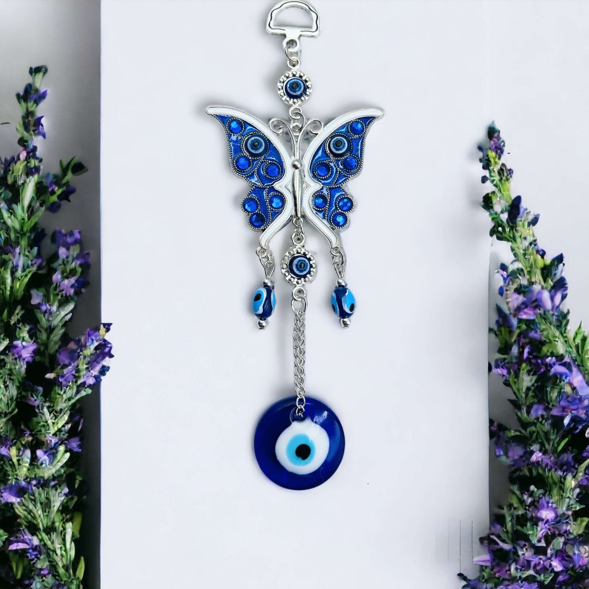 Butterfly evil eye hanger on white surface. 