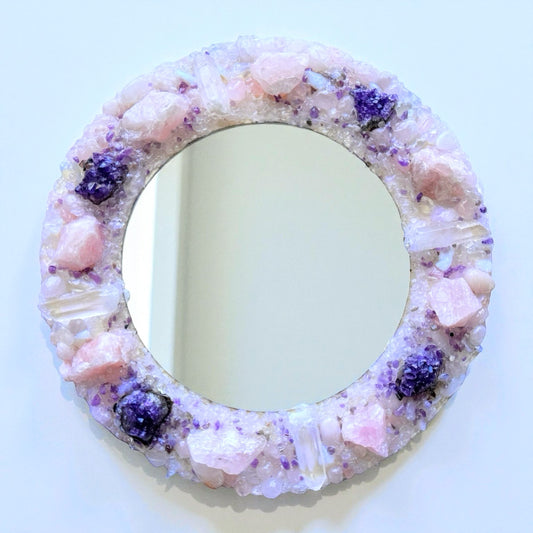 Crystal Mirror "Angel Bloom" 28cm with rose quartz and amethyst frame, featuring clear quartz points in soft pink and lilac tones.