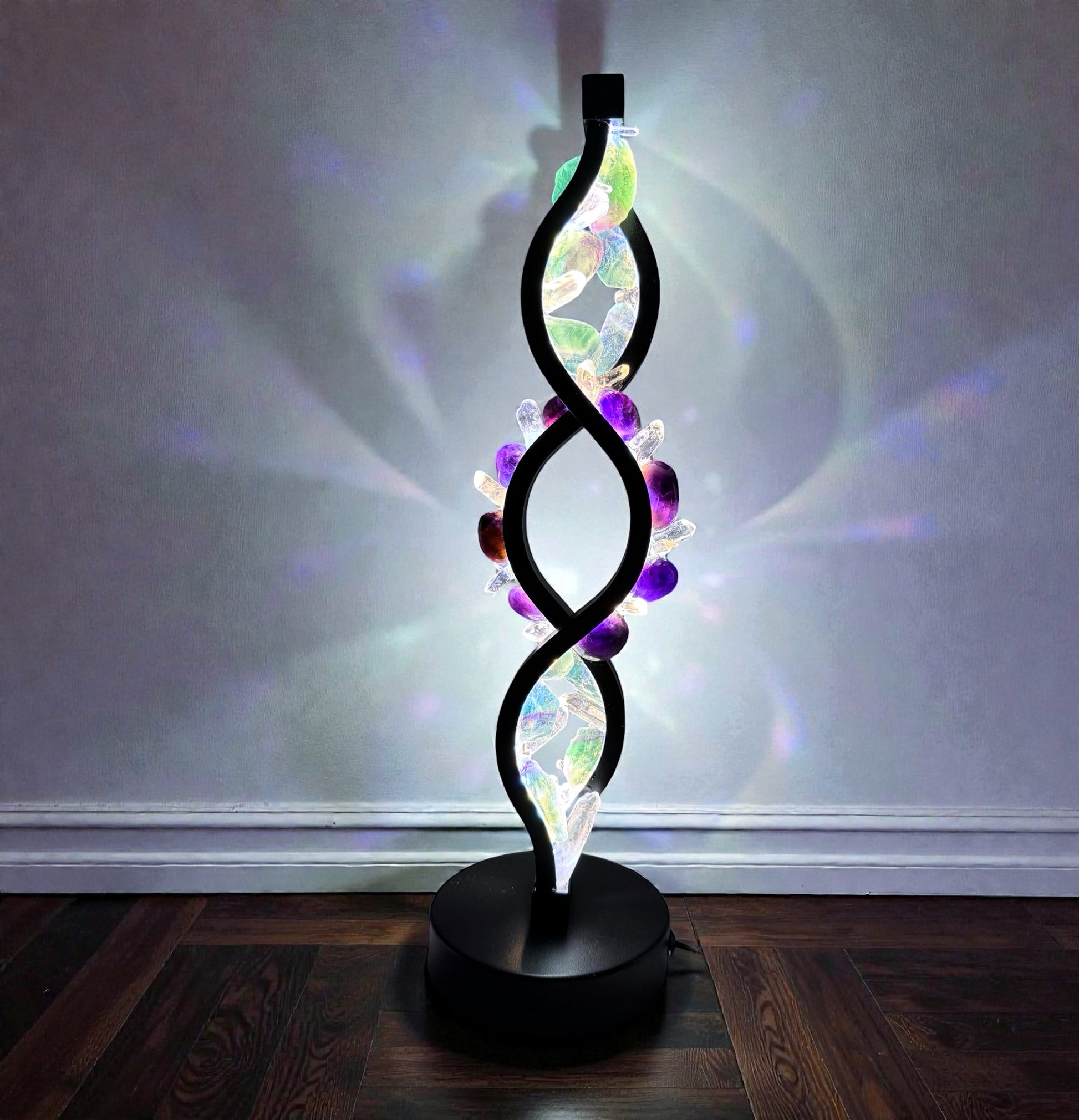 Crystal lamp Fluorite Twist with fluorite, amethyst, and clear quartz, 35cm, S-curve design, glowing in green and purple hues.