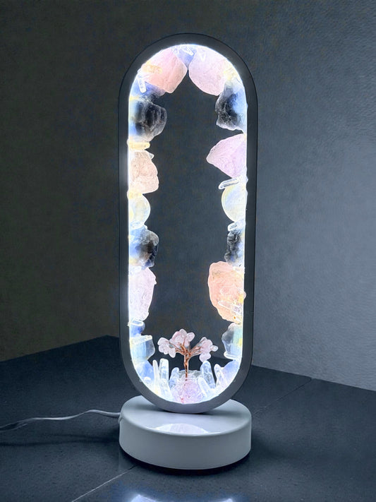 Crystal Portal Lamp "Twilight Grove" with rose quartz, blue calcite, and quartz crystals glowing on a dark background.