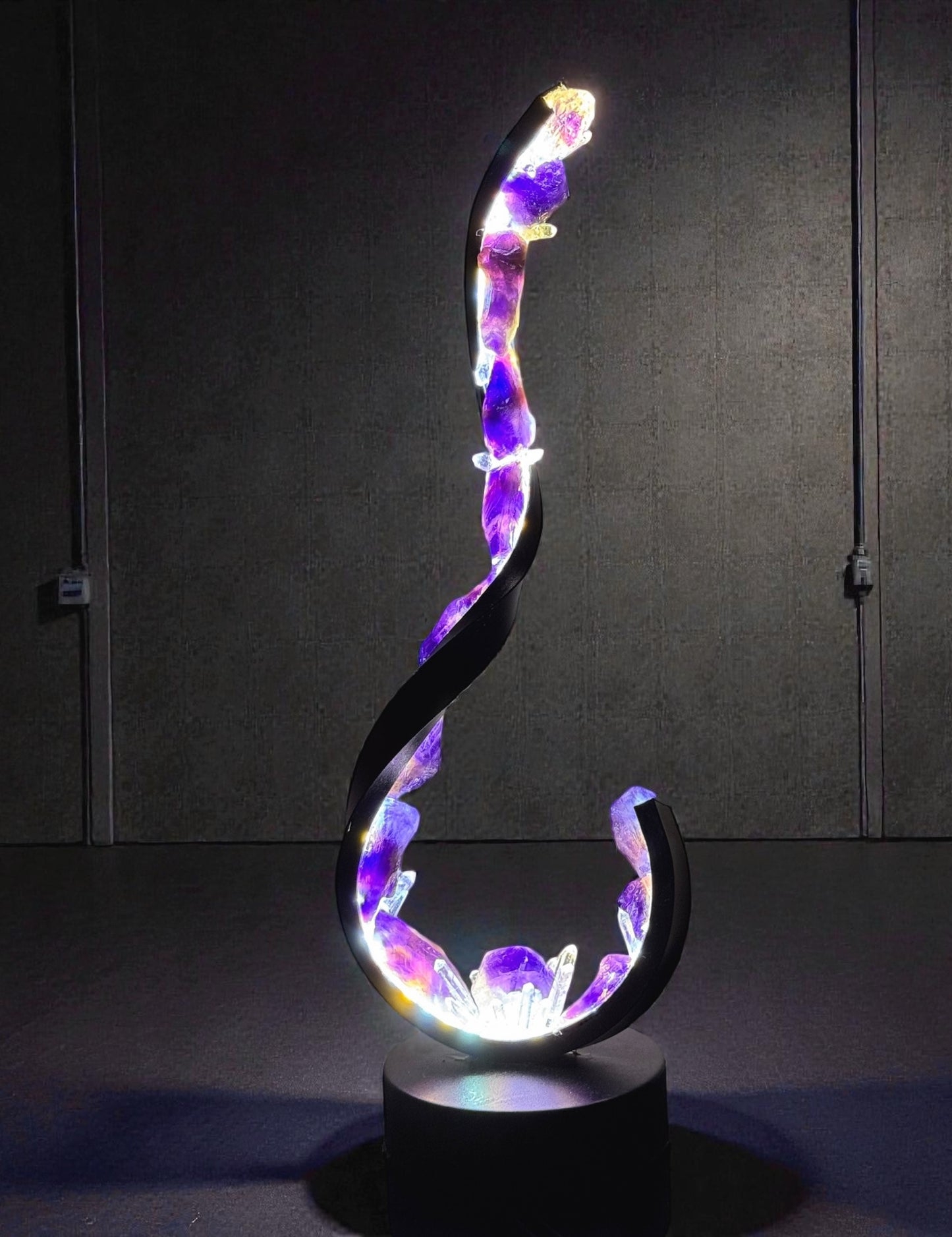 Crystal lamp featuring a wave-shaped design with raw amethyst and clear quartz, promoting calm and clarity in a stylish black frame