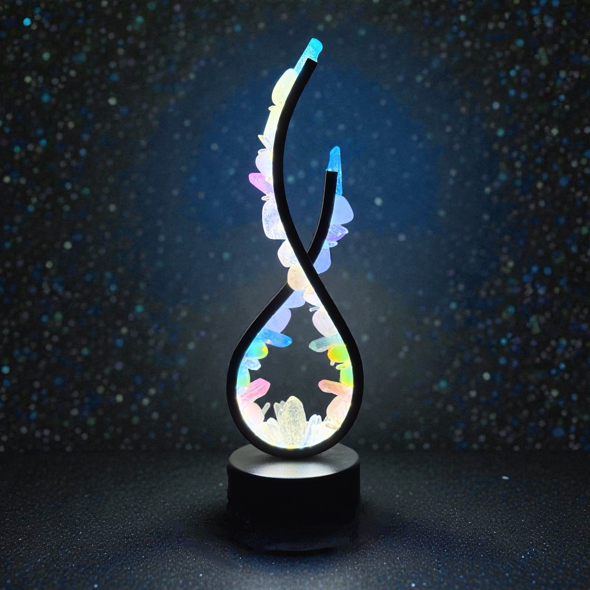 Crystal lamp with flame shape, featuring rose quartz and opalite, emits soft blush and iridescent hues for a calming ambiance.