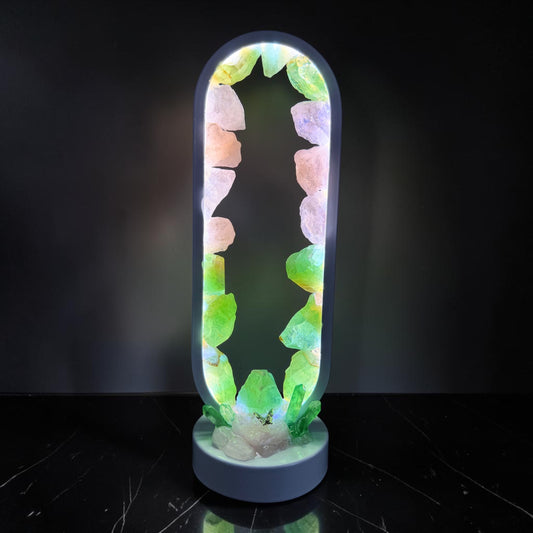 A glowing Fairy Grove Crystal Lamp showcasing green calcite and rose quartz crystals, enhancing any space.