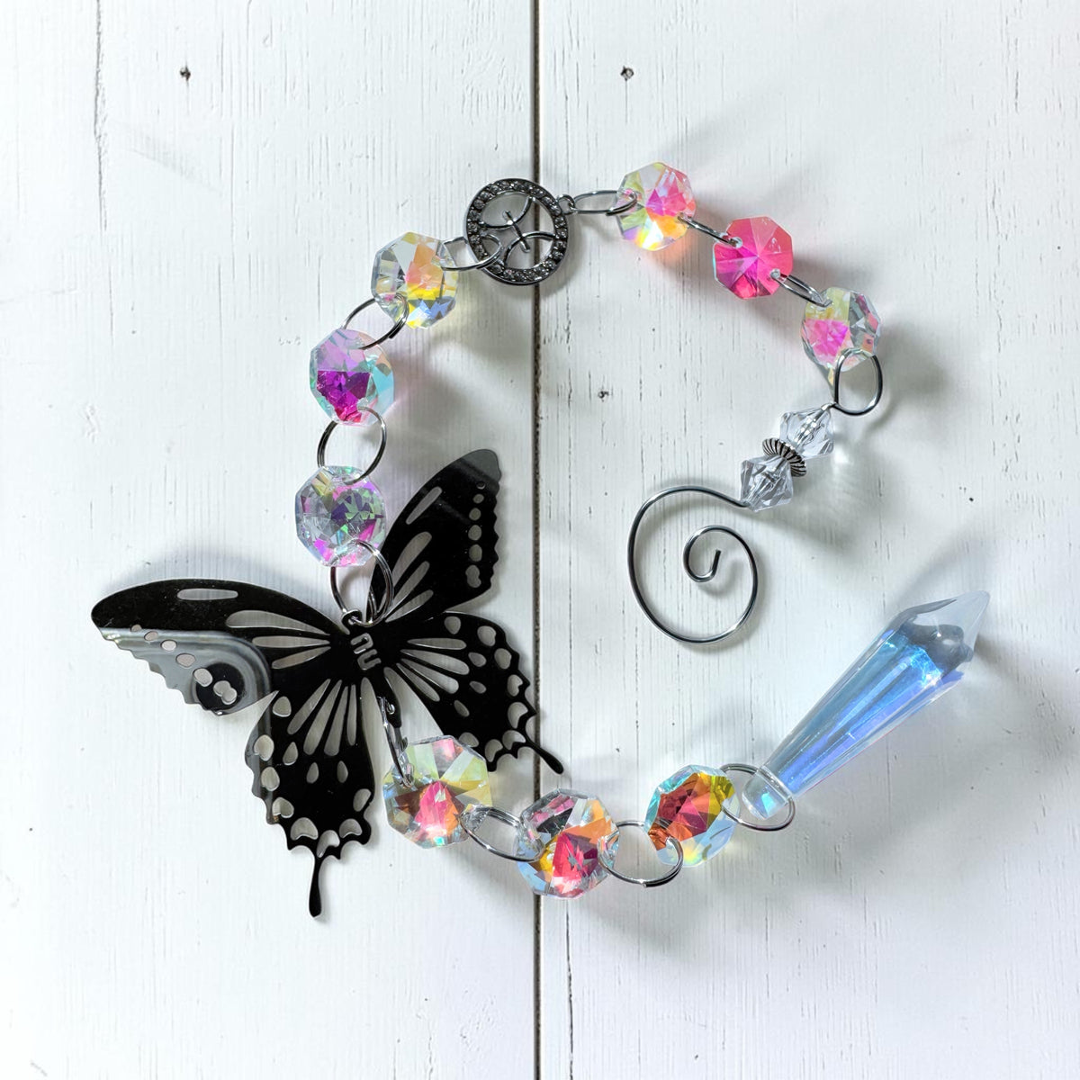 Star sign sun catcher featuring a silver butterfly and iridescent beads, perfect for home decor.