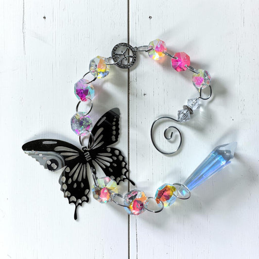 Star sign sun catcher featuring a silver butterfly and iridescent beads, perfect for home decor.
