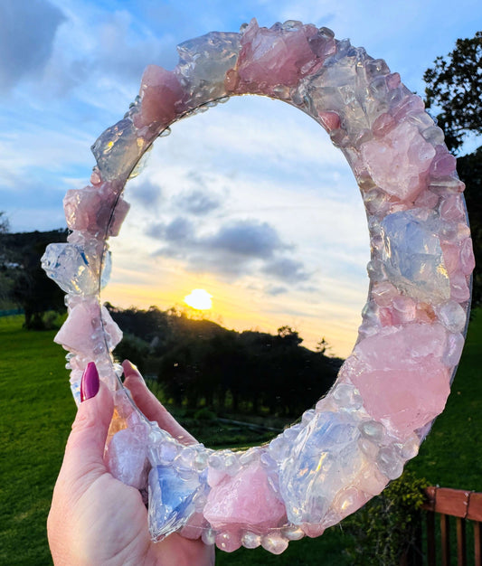 Handmade crystal mirror with gemstone border reflecting natural light