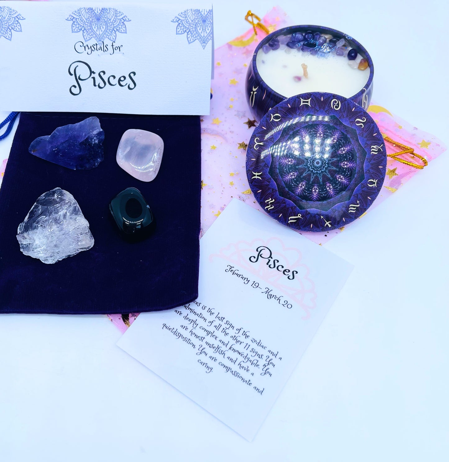 Gemini zodiac candle gift set with candle and four crystals for this sign sitting on a velvet bag.