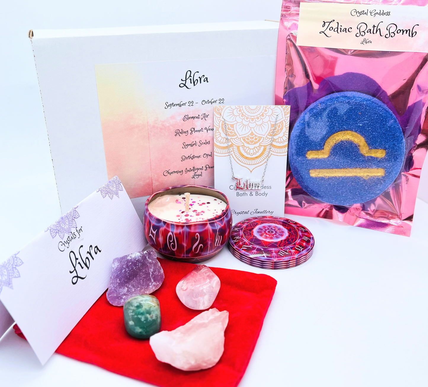 Libra zodiac gift box showing a set of four crystals, crystal candle, pendant and a bath bomb with the symbol for this sign on it.