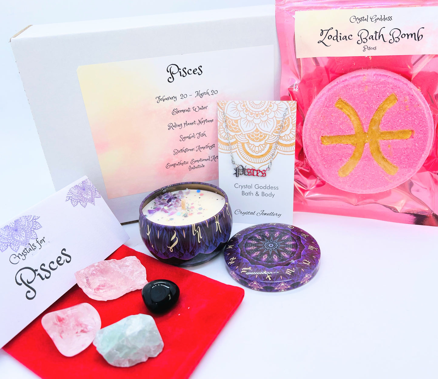Pisces zodiac gift box showing a set of four crystals, crystal candle, pendant and a bath bomb with the symbol for this sign on it.