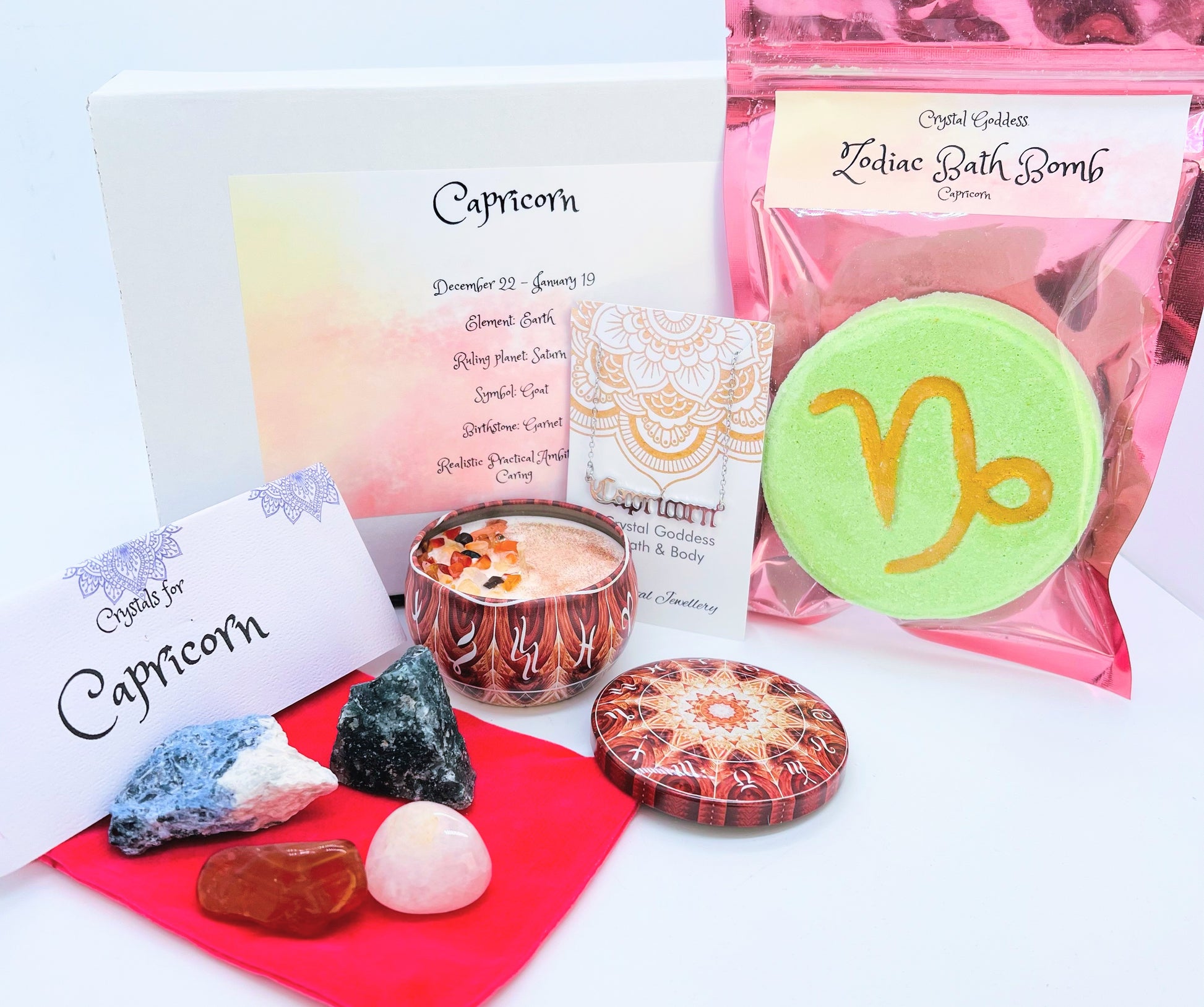 Capricorn zodiac gift box showing a set of four crystals, crystal candle, pendant and a bath bomb with the symbol for this sign on it.