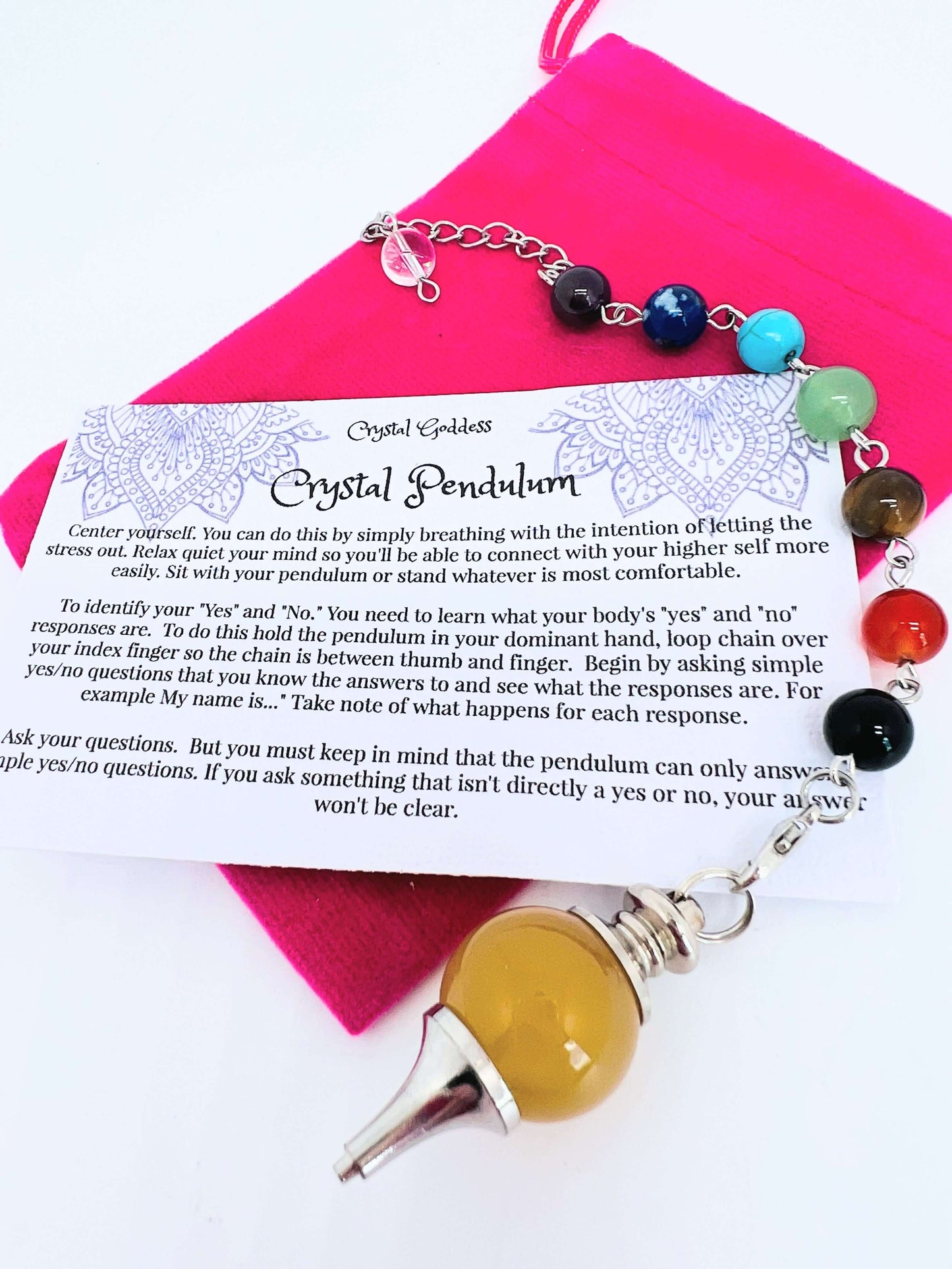 Crystal pendulum with chakra bead chain on pouch with instruction card