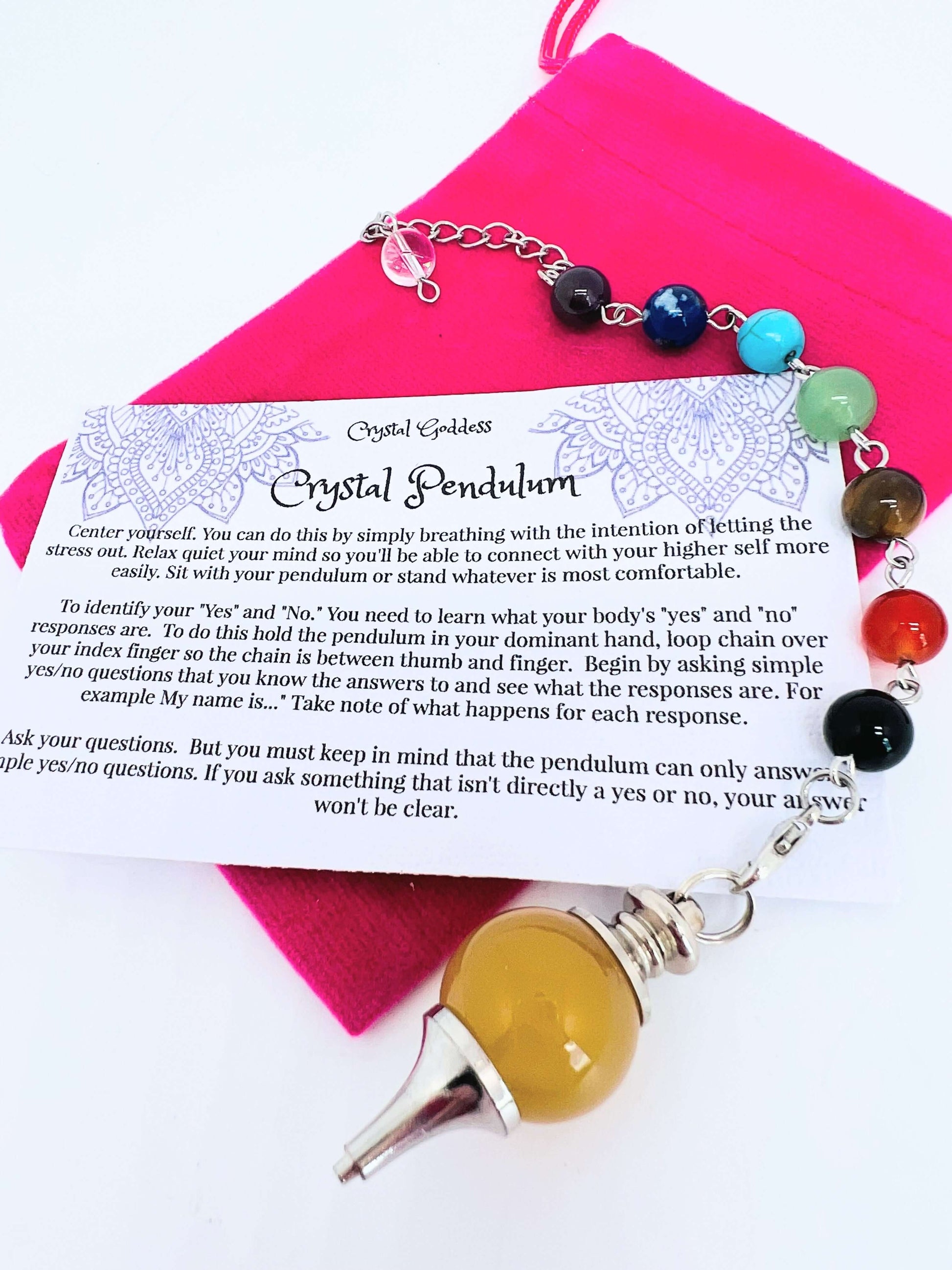 Crystal pendulum with chakra bead chain on pouch with instruction card